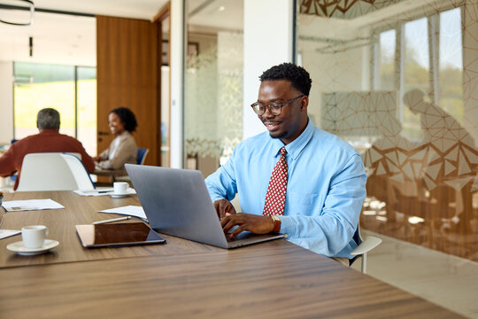 Businessman works in a shared office and uses his laptop