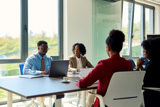 Four people in a meeting.