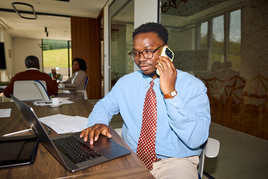 Businessman speaks on the phone while working