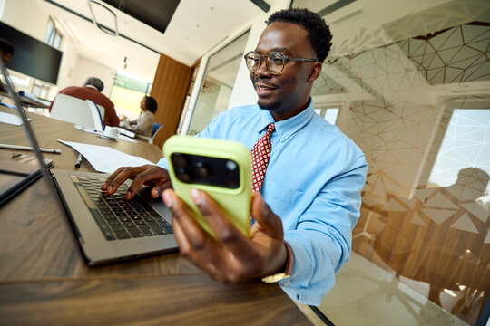 Man is engaging in a business while holding his phone
