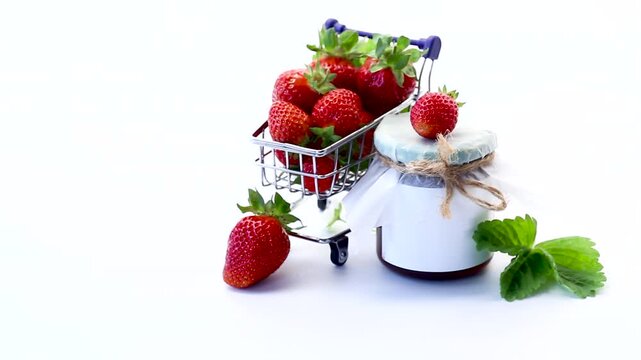 ripe strawberries and homemade jam isolated on white background