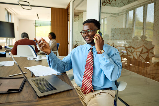 Businessman engaged in a phone conversation while working