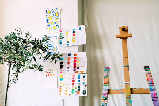 Creative art studio corner with easel, plant and color palette s