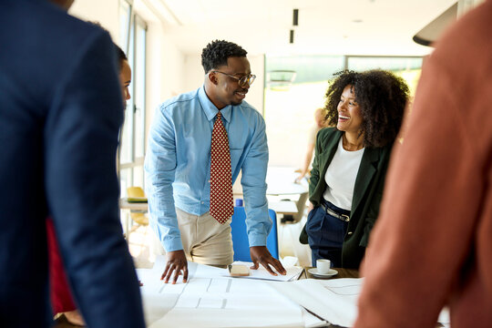Group of Professionals Stands Around a Table