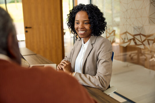 Woman smiles while conversing with a colleague