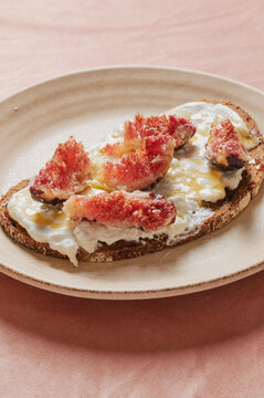 Bread slice with cheese spread figs and honey
