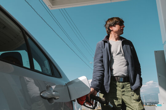 A man filling the gas tank in Japan