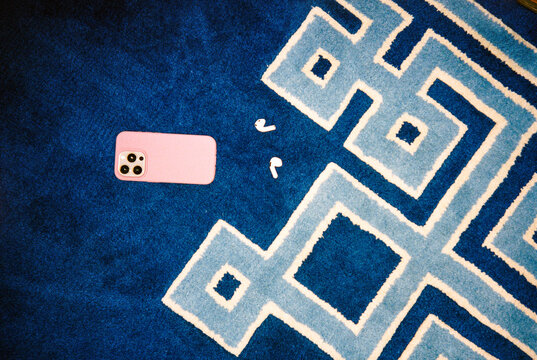 Cell phone and audio earbuds still life 