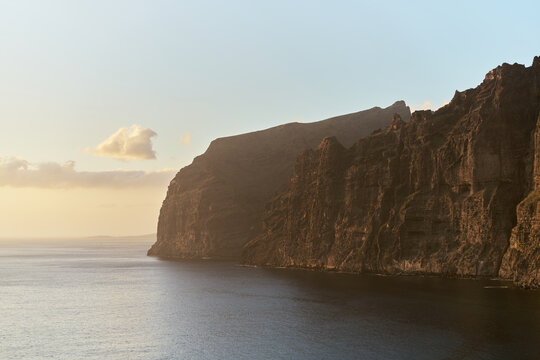 Dramatic Sea Cliffs at Sunset Over Calm Ocean Coastline