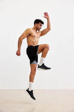 Man jumping in fitness workout in indoor space