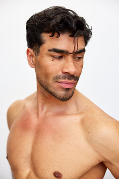 Man posing with a serious expression in a studio setting
