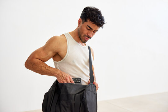Man checks bag for items at indoor space during the day