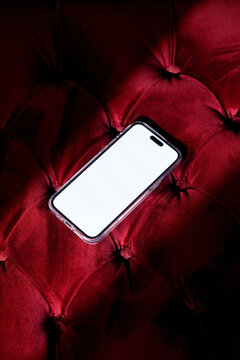 Mock-up phone with empty screen on red velvet background