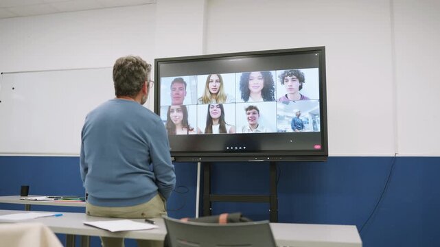 Teacher having an online lesson with students on a video conference call