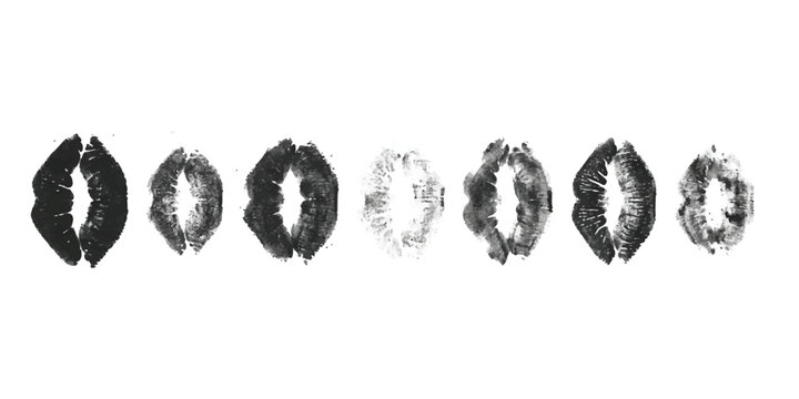 Set of seven black lipstick kiss marks and lip prints isolated on a plain surface