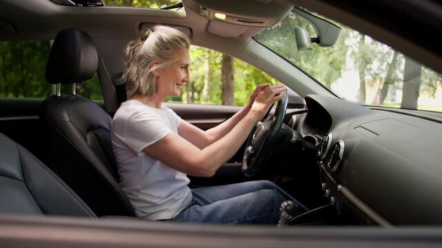 Caucasian old retired woman happy sitting in car smiling touching new salon steering wheel comfortable transport gray haired senior female sit in renting auto rent automobile buying leasing motorcar