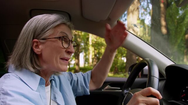 Angry Caucasian old woman driving car feeling rage problem traffic jam mad aggressive senior mature female driver yelling drive automobile stress aged lady in auto yell roadway transport accident