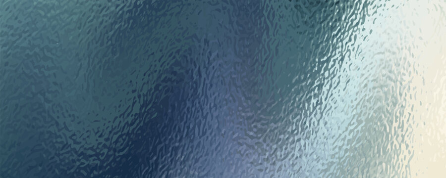 A close-up view of a textured surface, possibly frosted glass, with swirling patterns of blue and green.