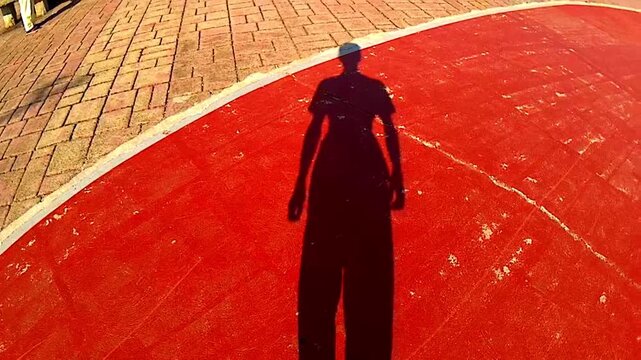 the shadow of a walking guy