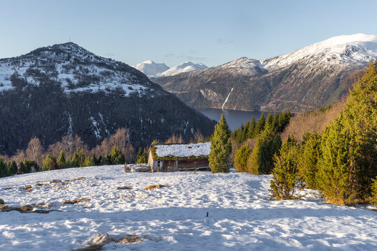 A beautiful winter landscape in Toresetra with old, traditional wooden building. A wintertime scenery near Eidsdal in Geiranger Unesco World Heritage site, More og Romsdale region, Norway.