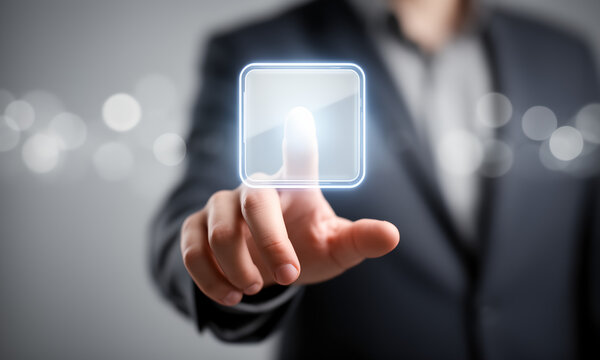 Businessman in a suit interacting with a futuristic digital glass touchscreen interface button