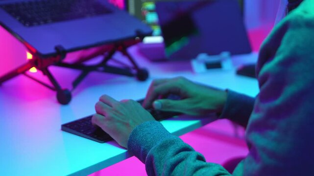 Hands of a Programmer Typing on a Keyboard in a High-Tech Workspace for Coding and Security