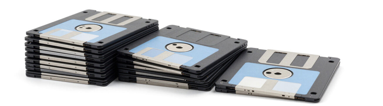 stack old inch floppy diskettes slight wear tear arranged tiered flat lay composition soft diffused studio