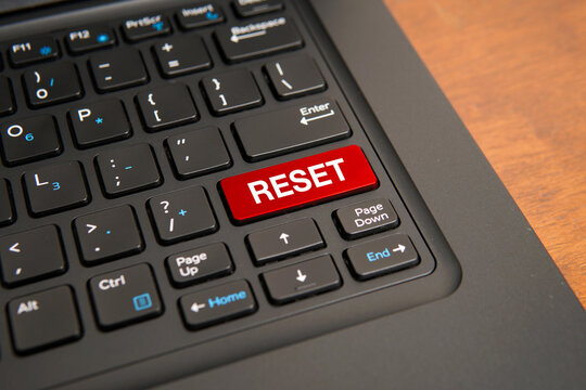 Close up of a computer keyboard with a red reset key, representing restarting, recovery, renewal, fresh start, system reset, troubleshooting, and business transformation concepts.