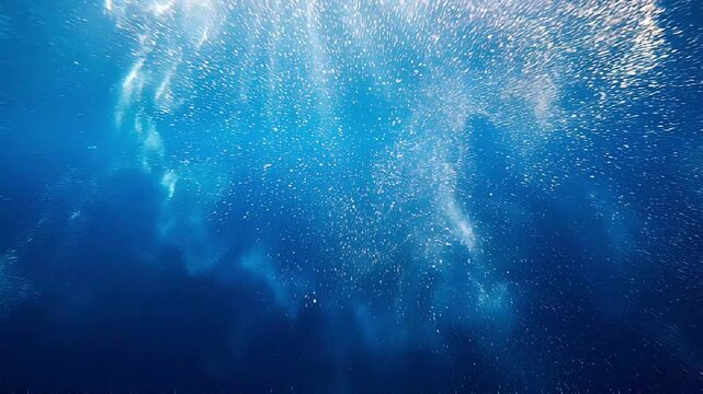 Underwater Symphony of Light and Bubbles: Sunlight filters through the deep blue ocean, illuminating a mesmerizing dance of tiny bubbles and swirling currents.