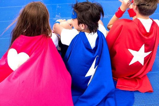 Children in colorful superhero capes