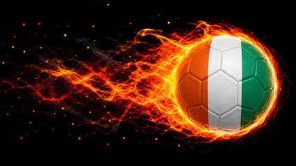 Fototapeta premium A high-energy image of a soccer ball textured with the Ivory Coast national flag, trailing intense orange and yellow flames against a black background.