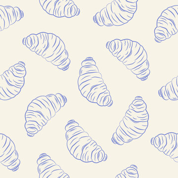 Seamless pattern with hand drawn croissants on cream background.