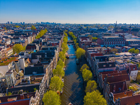 Oudezijds Voorburgwal canal with Dutch style waterfront building in Central Amsterdam, Netherlands. Canal Ring Area of Amsterdam is designed as a UNESCO World Heritage Site. 