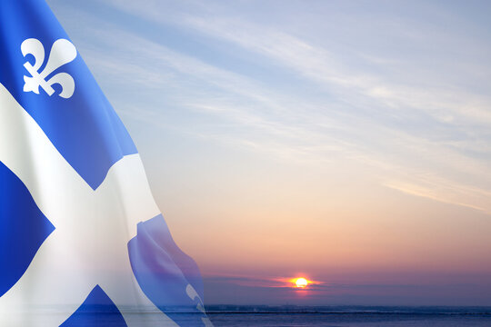 Flag of Quebec - Province of Canada - against the sunset. Quebec Day. Saint-Jean-Baptiste Day