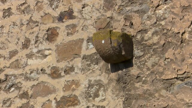 Stone wall texture with protruding architectural block element masonry rock