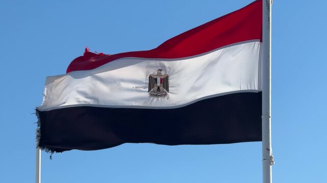 Egyptian flag on a ship against blue sky, sailing, national symbol, maritime pride, sunny voyage.