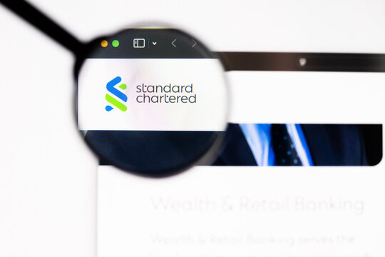 Milan, Italy 2026, 20 Apr Closeup of Standard Chartered website on a laptop screen. Standard Chartered logo under a magnifying glass.