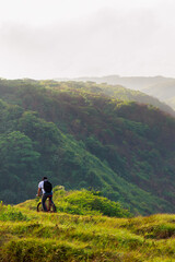 Obraz premium Cyclist looking at a scenic mountain landscape in Nicaragua