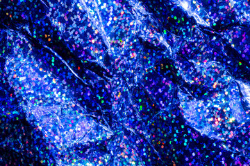 Obraz premium Blue holographic glitter texture with sparkling bokeh and crumpled metallic foil background
