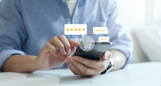 close up man hand hold smartphone and checking rating score of product on marketplace website before make cashless payment by credit card for customer satisfy and online shopping concept