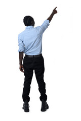 Fototapeta premium back view of a young man pointing up on white background