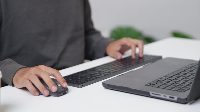 Close-up of Hands Typing on a Keyboard During Remote Work Setup with Technology