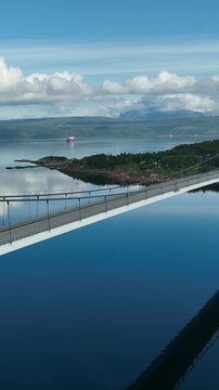 Aerial shot of the Halogaland Suspension Bridge near the town of Narvik in Northern Norway. Vertical Video.