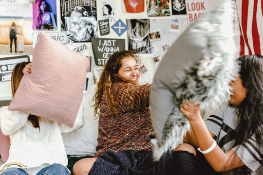 Friends enjoying fun pillow fight