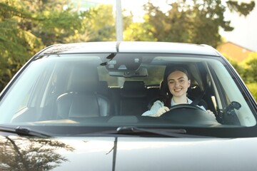 Fototapeta premium Woman driving modern car, view through windshield