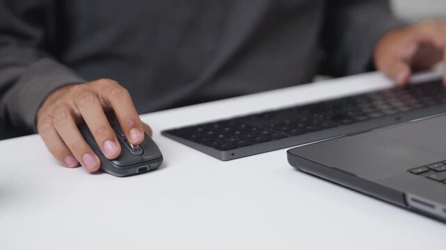 Close-Up of a Programmer Working with a Mouse and Keyboard in a Digital Environment