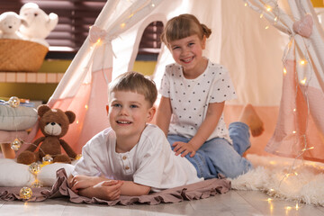 Little girl and boy near wigwam at home, selective focus © New Africa