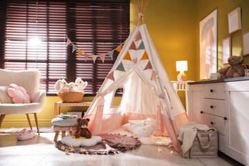 Beautiful wigwam, cushions and toys in child's room © New Africa