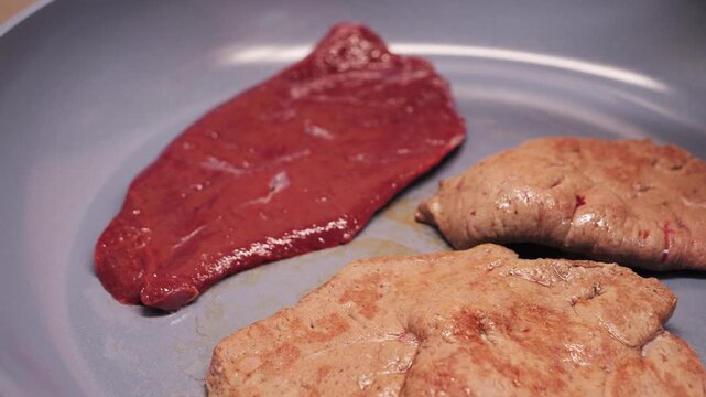 Homemade preparation of beef liver steaks in a pan, simple and delicious dietary meal concept. High quality 4k footage