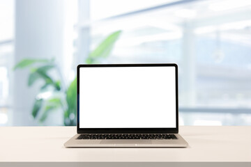 Fototapeta premium close up isolated on blank white screen display of laptop computer on table inside office room for add content of design banner , website or template or online shopping e-commerce concept